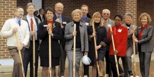 Group of college officials with shovels at 2002 groundbreaking event
