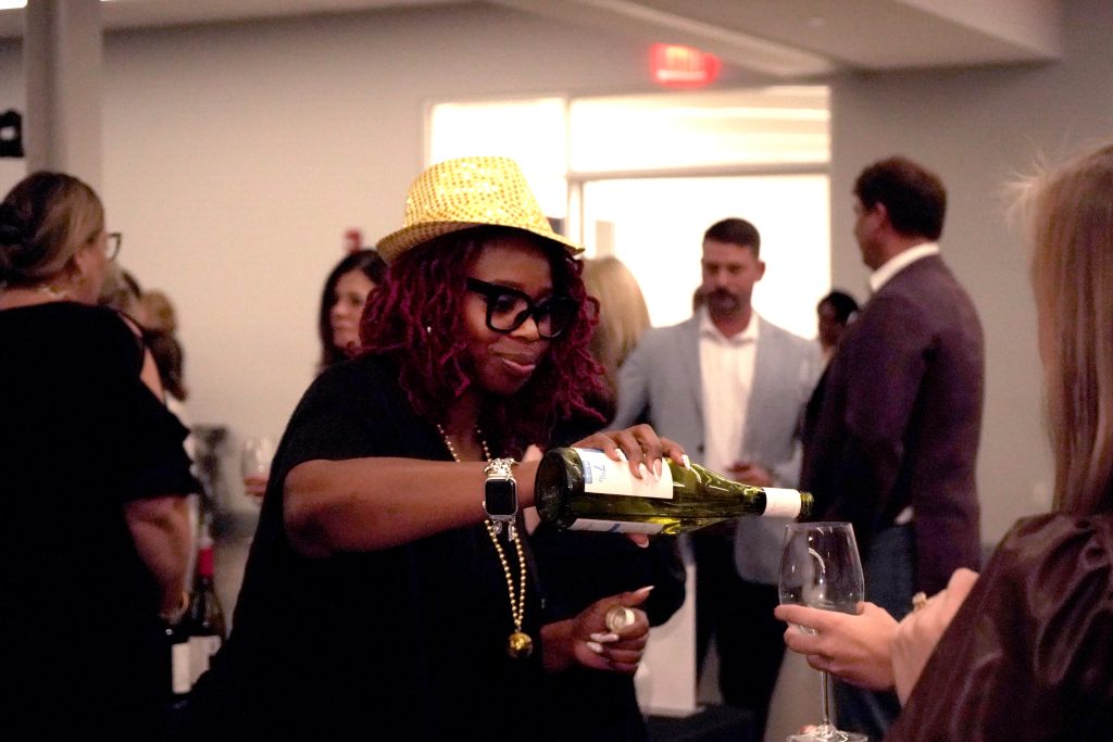 OCtech Foundation volunteer Courtney Brown serves guests during the 2025 Webber Evening of Fine Wines and Food.