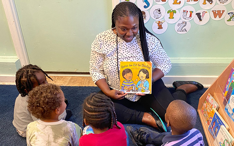 pre-school teacher reading to children