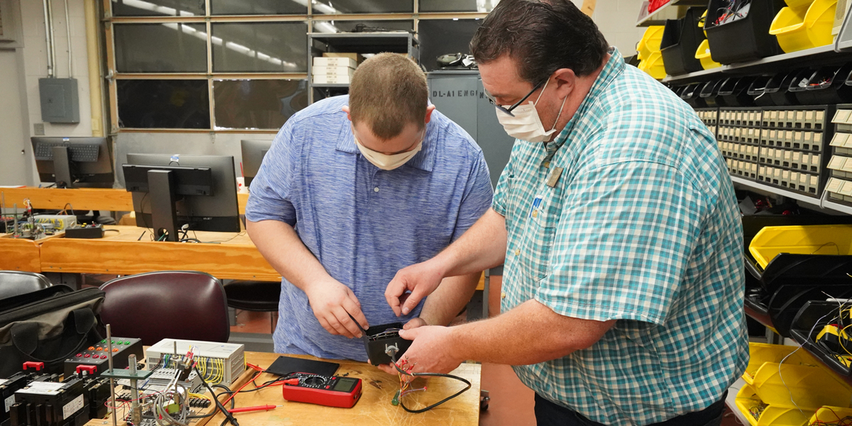 instructor and student in electronics lab
