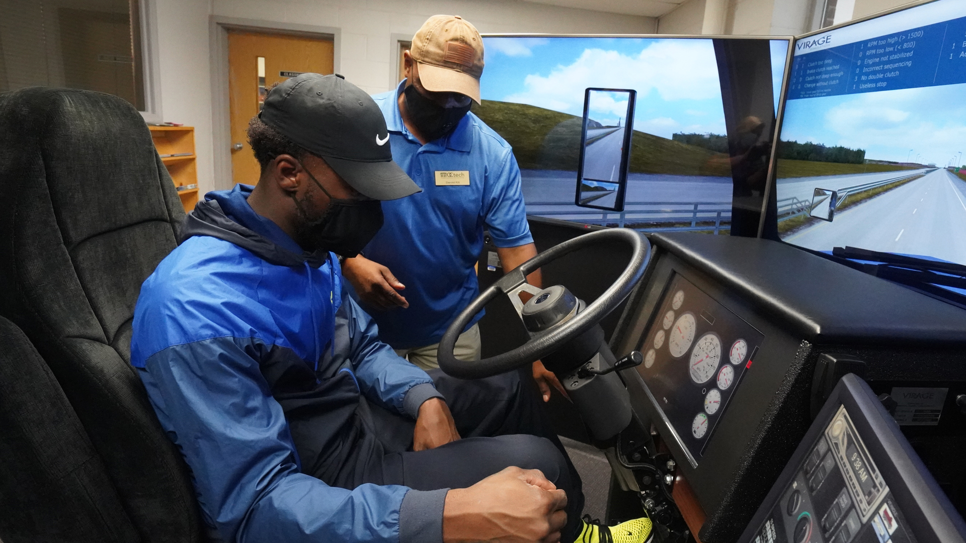 instructor with student in Truck Driving Simulator