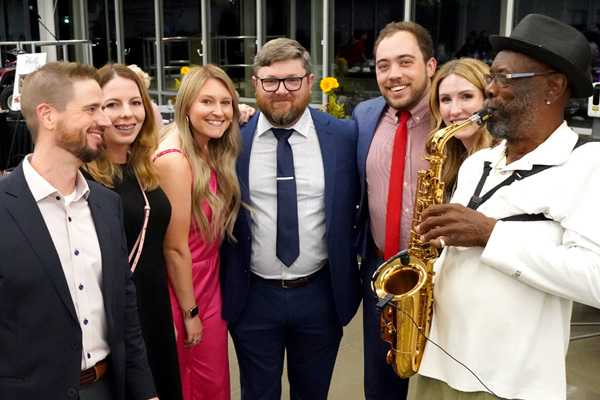 attendees with sax player at wine event
