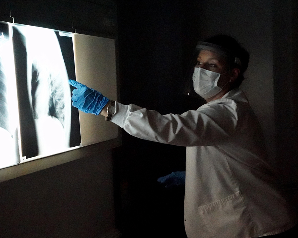 Radiology instructor examining x-rays